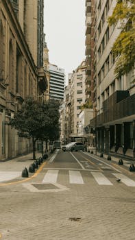 View of a calm street in Buenos Aires lined with buildings and trees, perfect for urban exploration.