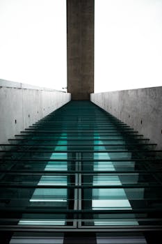 A dramatic view of modern architecture featuring glass and concrete elements.