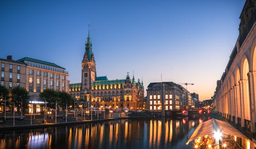 A city with a river and buildings at night