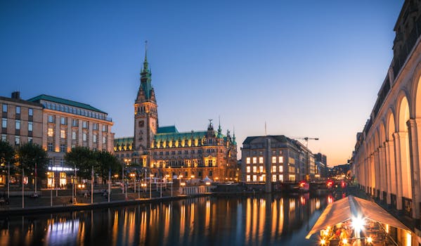 Explore the illuminated Hamburg Rathaus and canal at dusk, capturing architectural elegance in Germany.