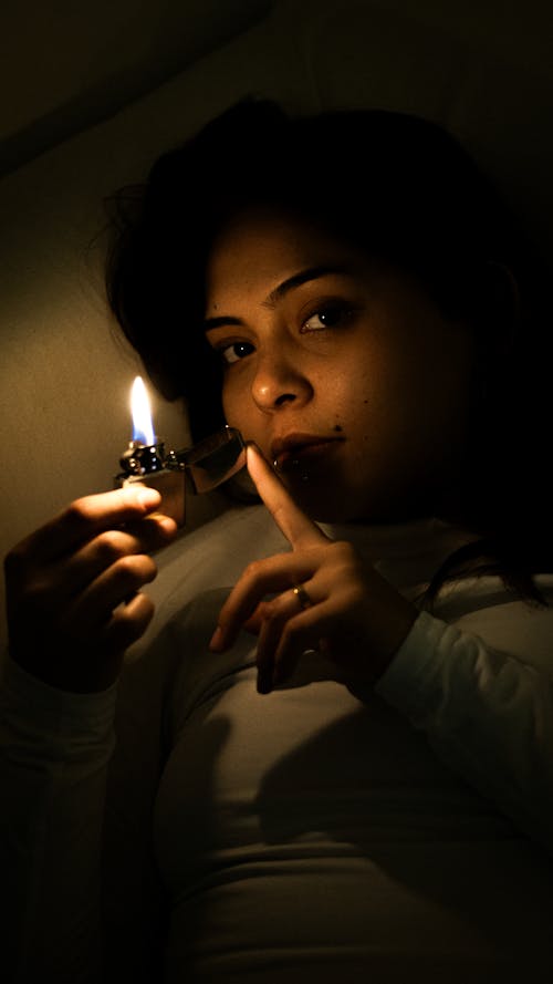 Woman Holding a Candle in the Dark
