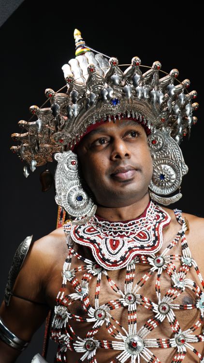 Traditional Kandyan dancer wearing elaborate costume and crown in Sri Lanka