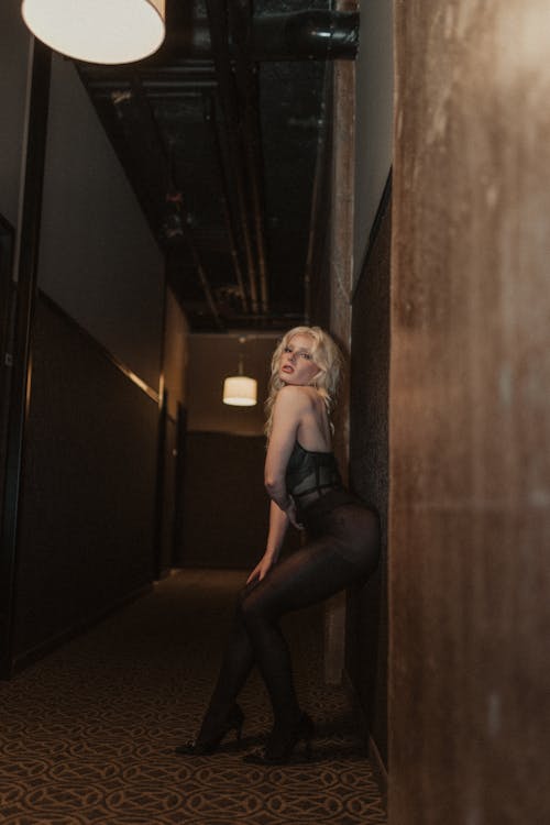 Blonde Woman in Lingerie Posing in Corridor