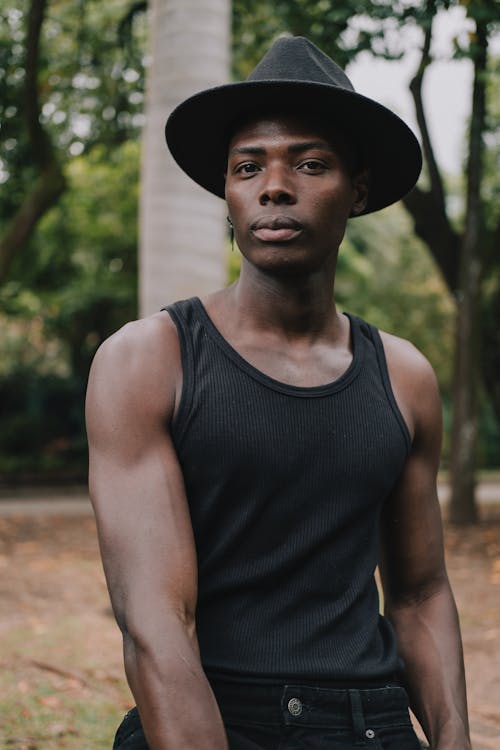 Man Wearing a Hat and a Tank Top 