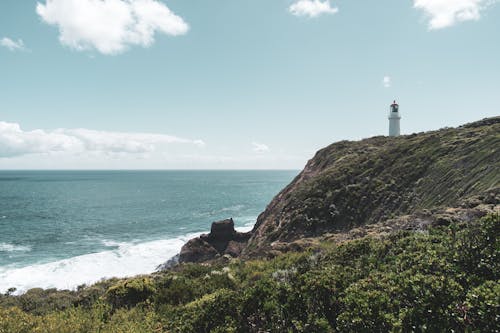 Photo of a Coast with a Lighthouse 