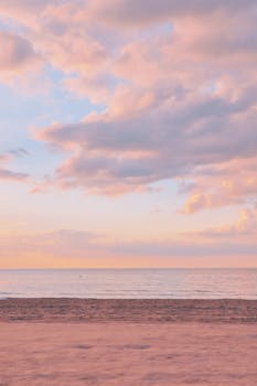 Tranquil sunset over the Jūrmala coast, showcasing pastel skies and calm seas.