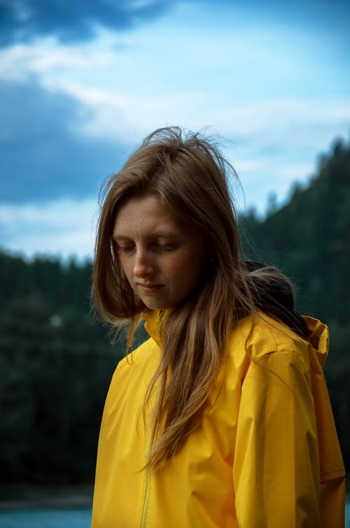 Blonde Woman in Yellow Raincoat with Hood