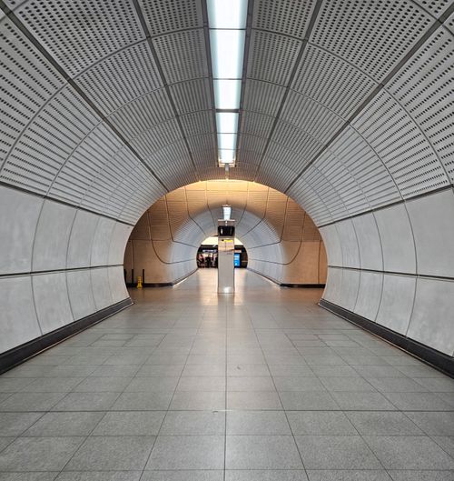 Free Explore the modern and symmetrical tunnel at Tottenham Court Road Station in London, England. Stock Photo