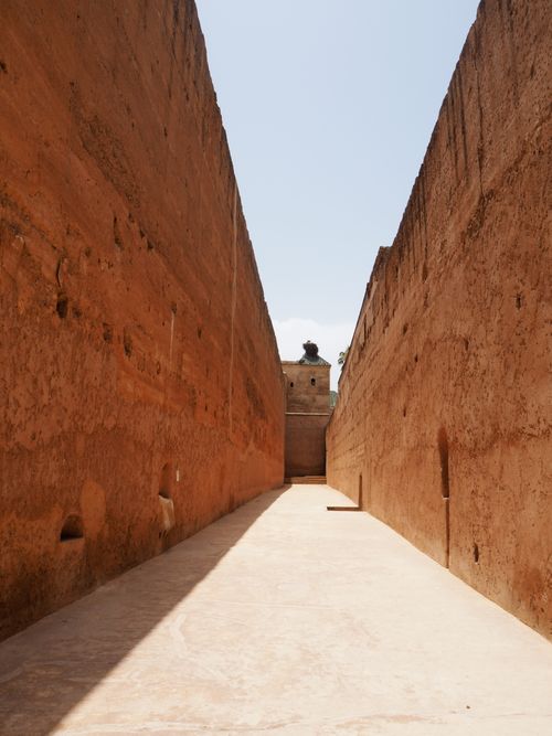 Free Explore the narrow stone alley within Badi Palace, a landmark in Marrakech, Morocco. Stock Photo