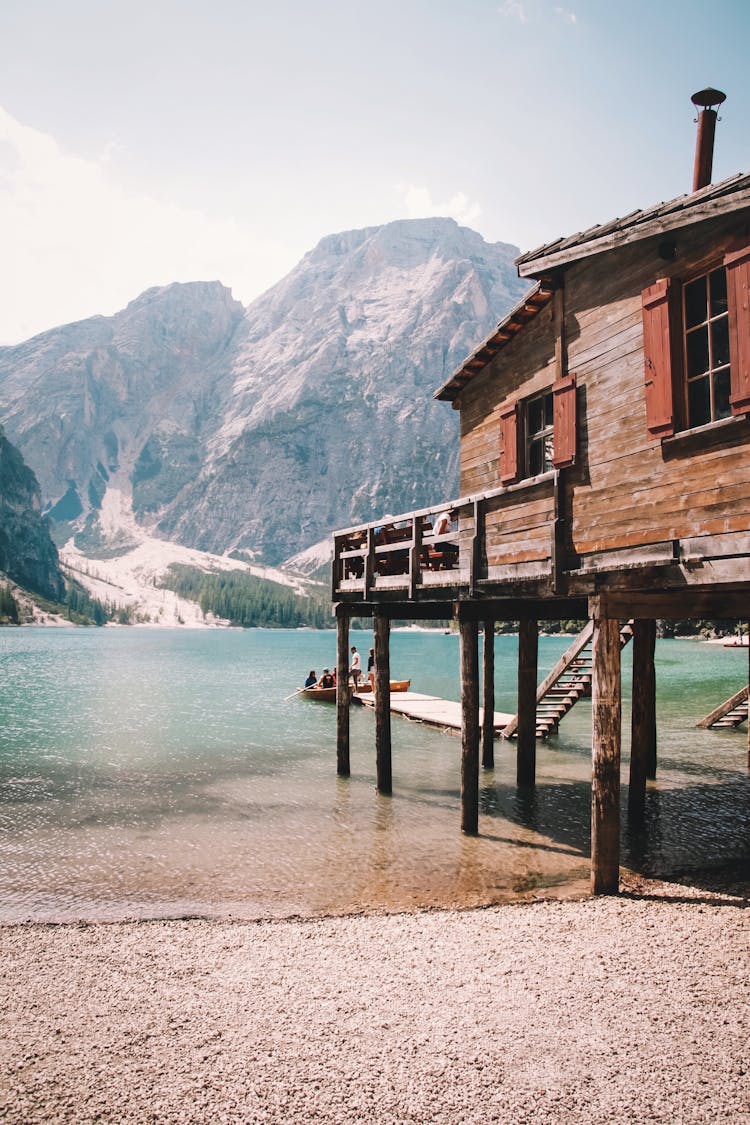 Wooden House On Pillars At Mountain Lake