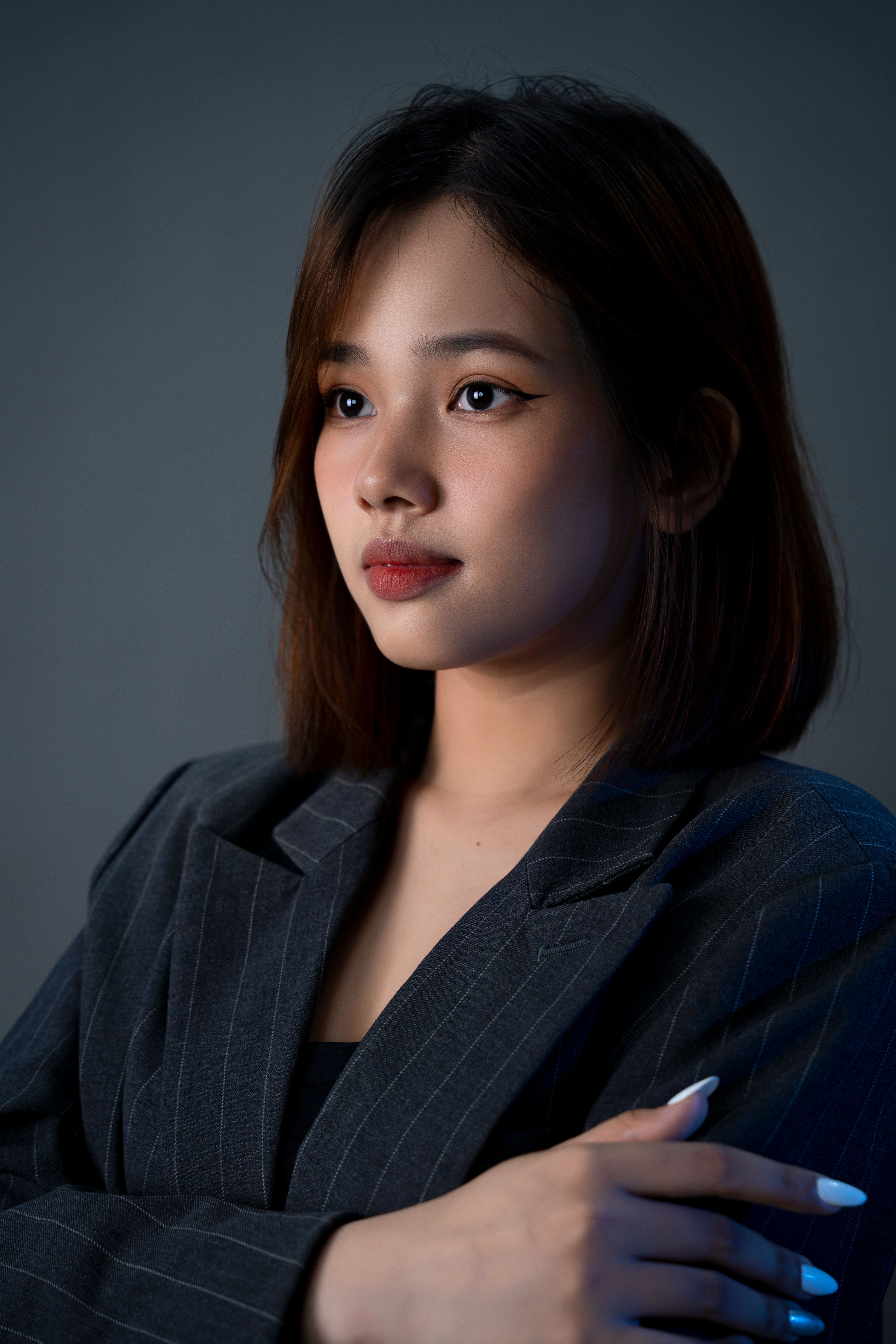 Portrait of a young woman in a business blazer, exuding professionalism and confidence.