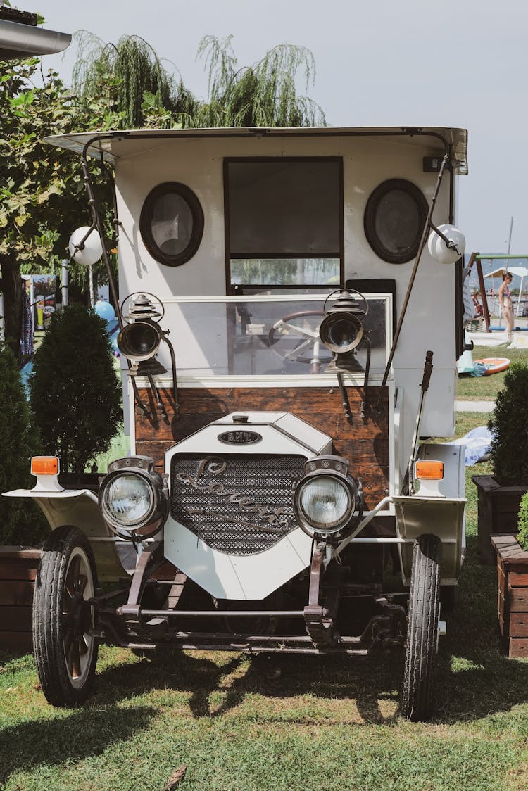 An Antique Car Parked On The Grass