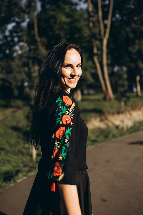 Brunette Woman Posing in Black Embroidered Blouse and Skirt