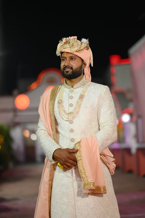 Free Man in traditional attire with turban at night, showcasing cultural elegance. Stock Photo