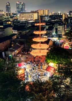 Aerial view of a lantern festival in Nagoya, Japan, showcasing vibrant lights and a festive crowd.