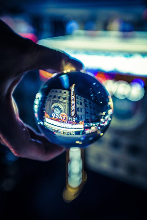 Close-Up Photo of Person Holding Lensball