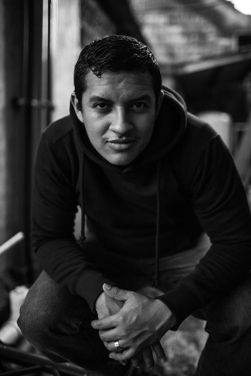 Black-and-White Photography of a Man in Hooded Sweatshirt