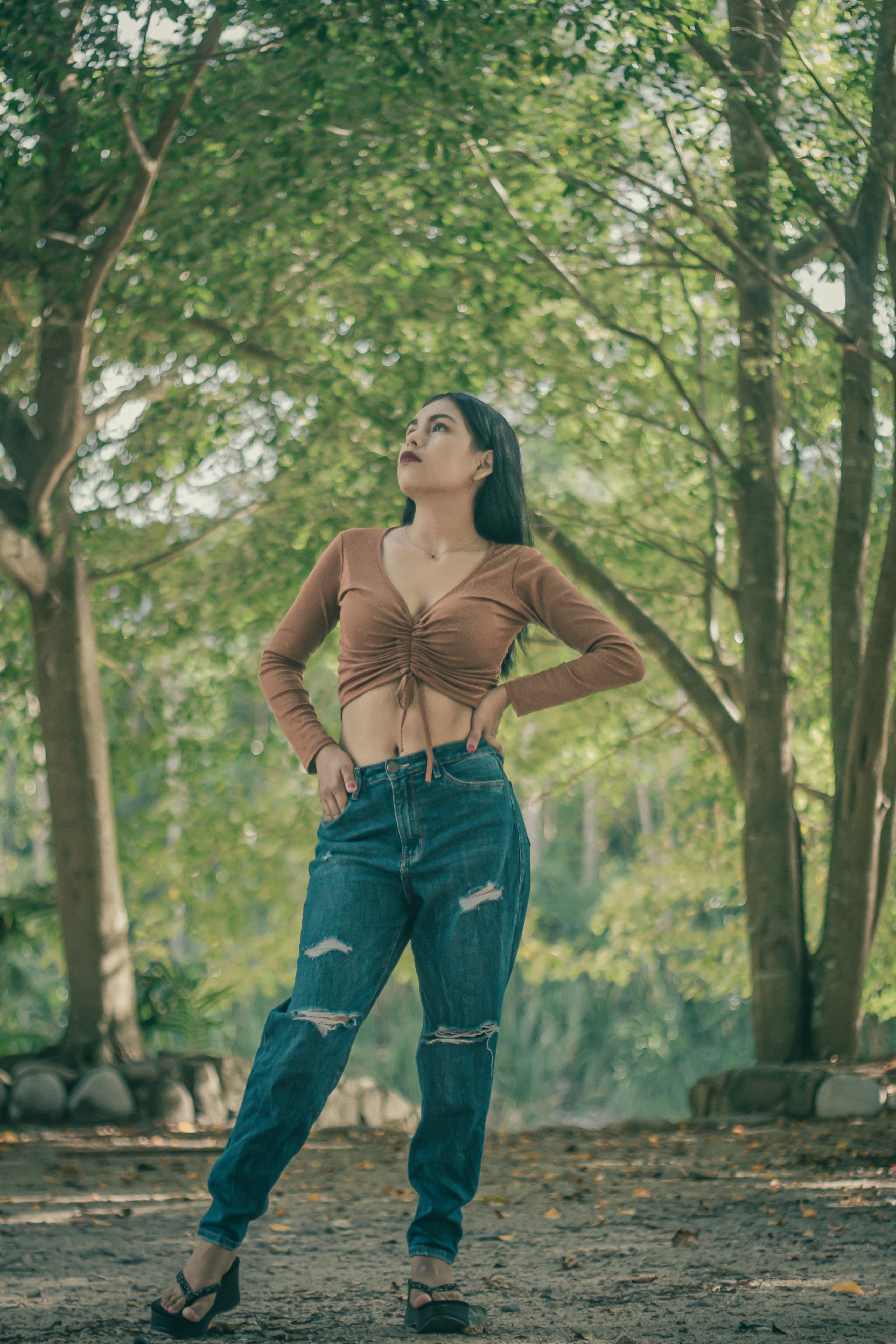 Pretty Stylish Brunette Girl In Blue Jeans And White Blouse Posing In  Summer Park Background Stock Photo, Picture and Royalty Free Image. Image  130042484.