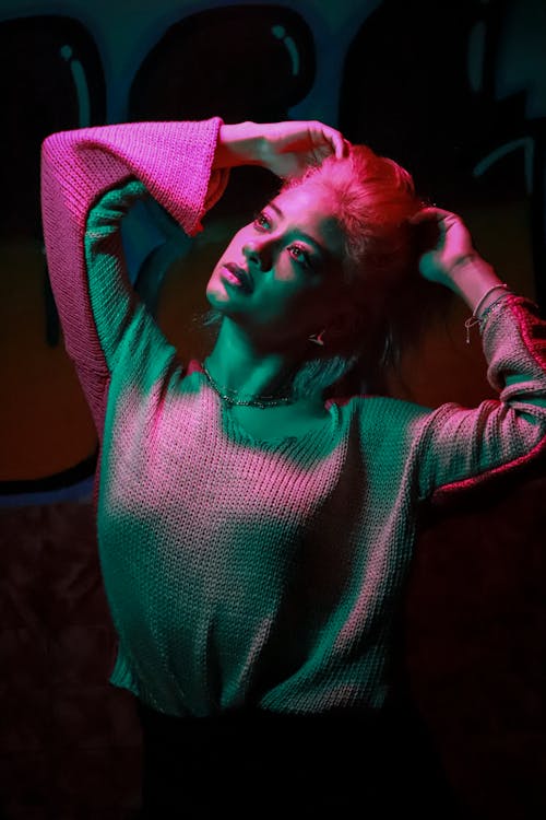 A Woman in a Green and Pink Light