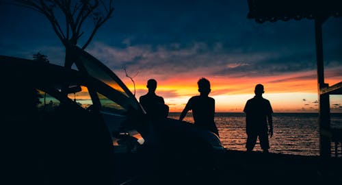 Silhouette Photo of People Near Beach