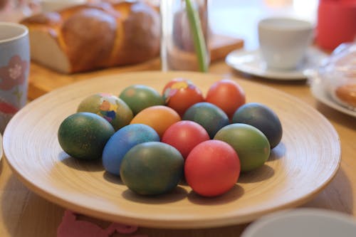 Colorful Eggs on a Wooden Plate 