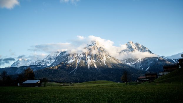 Beautiful snowcapped mountains in Austria's Tyrol region during a clear winter day.