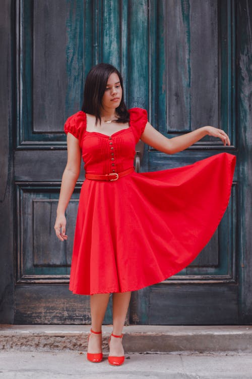 Model in Red A-Line Midi Dress in front of an Old Wooden Door