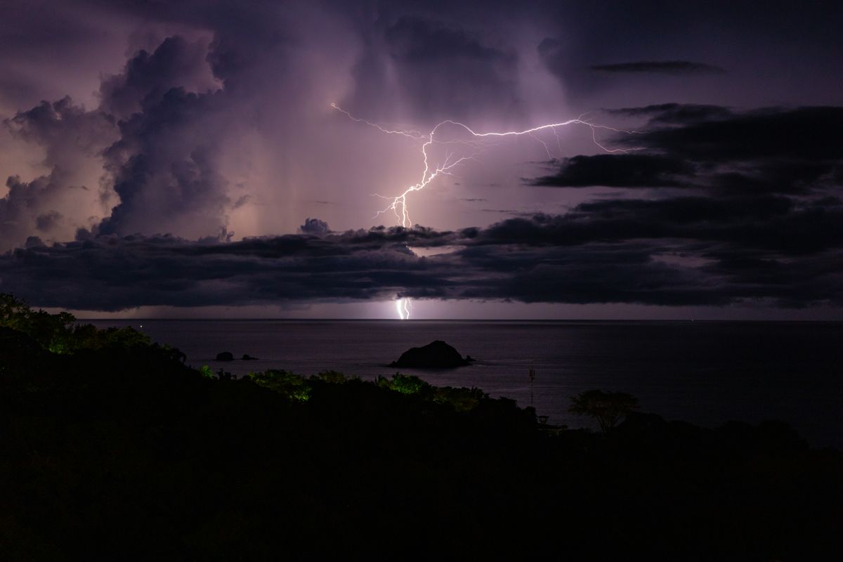 Lightning illuminating a dark sea during a thunderstorm, the tropical storm that chased the boat back to Koh Samui