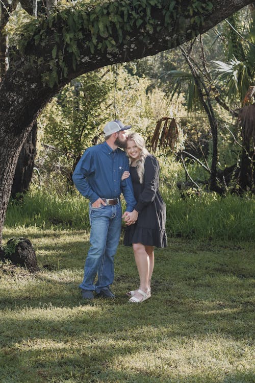 Just Engaged Couple Standing Under a Tree