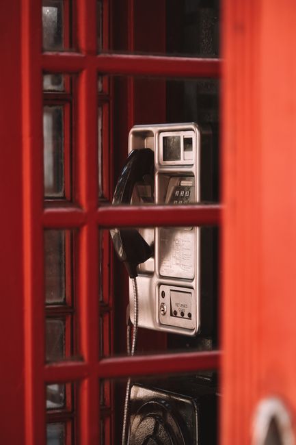 Vintage red telephone booth in London showcasing traditional British design.
