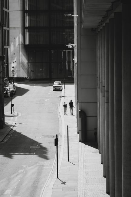 A modern black and white cityscape featuring pedestrians in London, England.