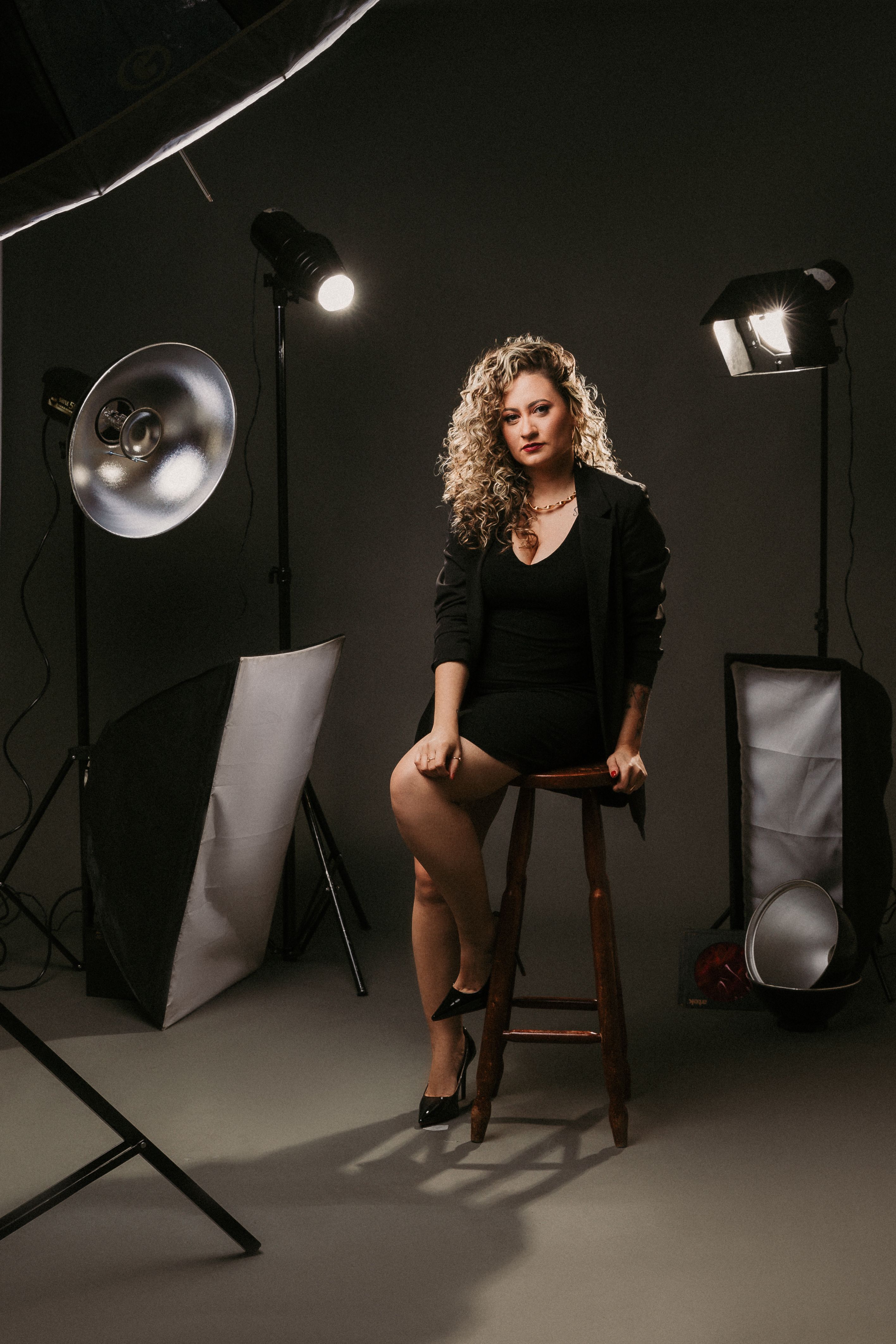 Model Sitting on a Stool in a Photo Studio · Free Stock Photo