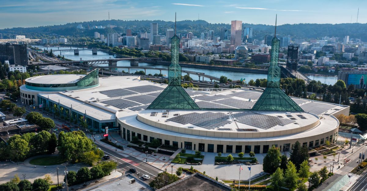 Stunning aerial view of the Oregon Convention Center with Portland skyline in the background.