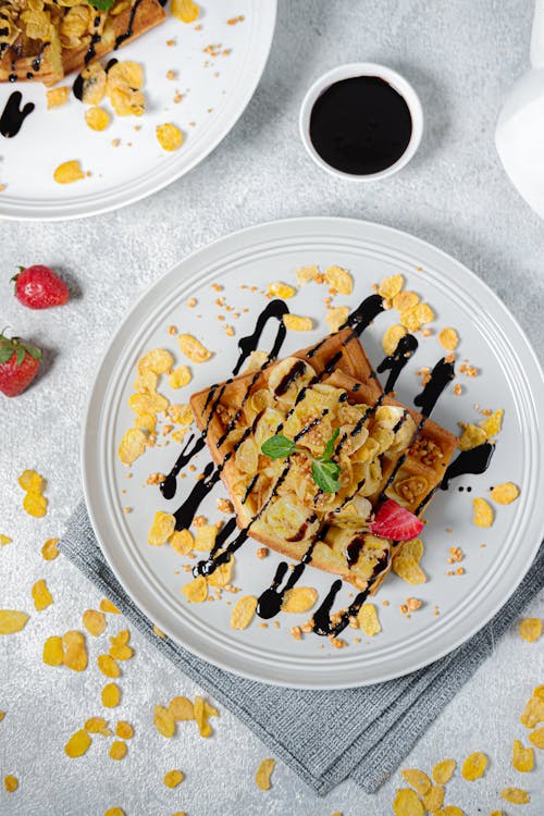 Free Top View of Waffles with Cornflakes, Fruit and Syrup  Stock Photo