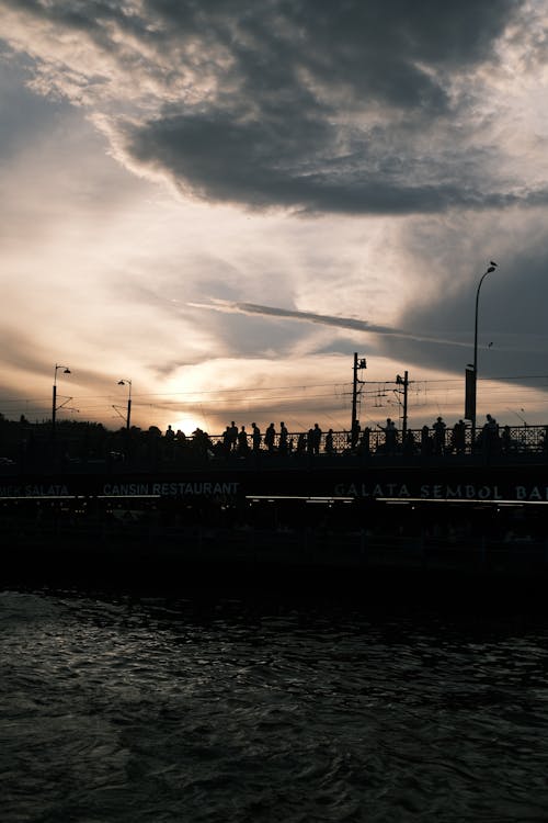 Silhouettes of People on Bridge in Istanbul