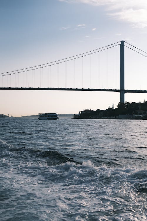 Ferry Boat Sailing under Fatih Sultan Mehmet Bridge in Bosphorus Strait, Istanbul, Turkey