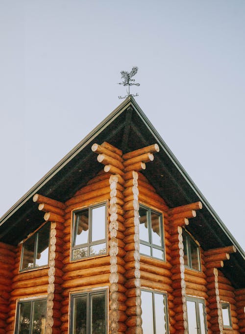 Exterior of a Wooden House with a Weather Vane on the Roof 