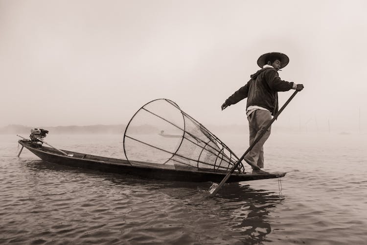 Fisherman On Fishing Boat In Black And White