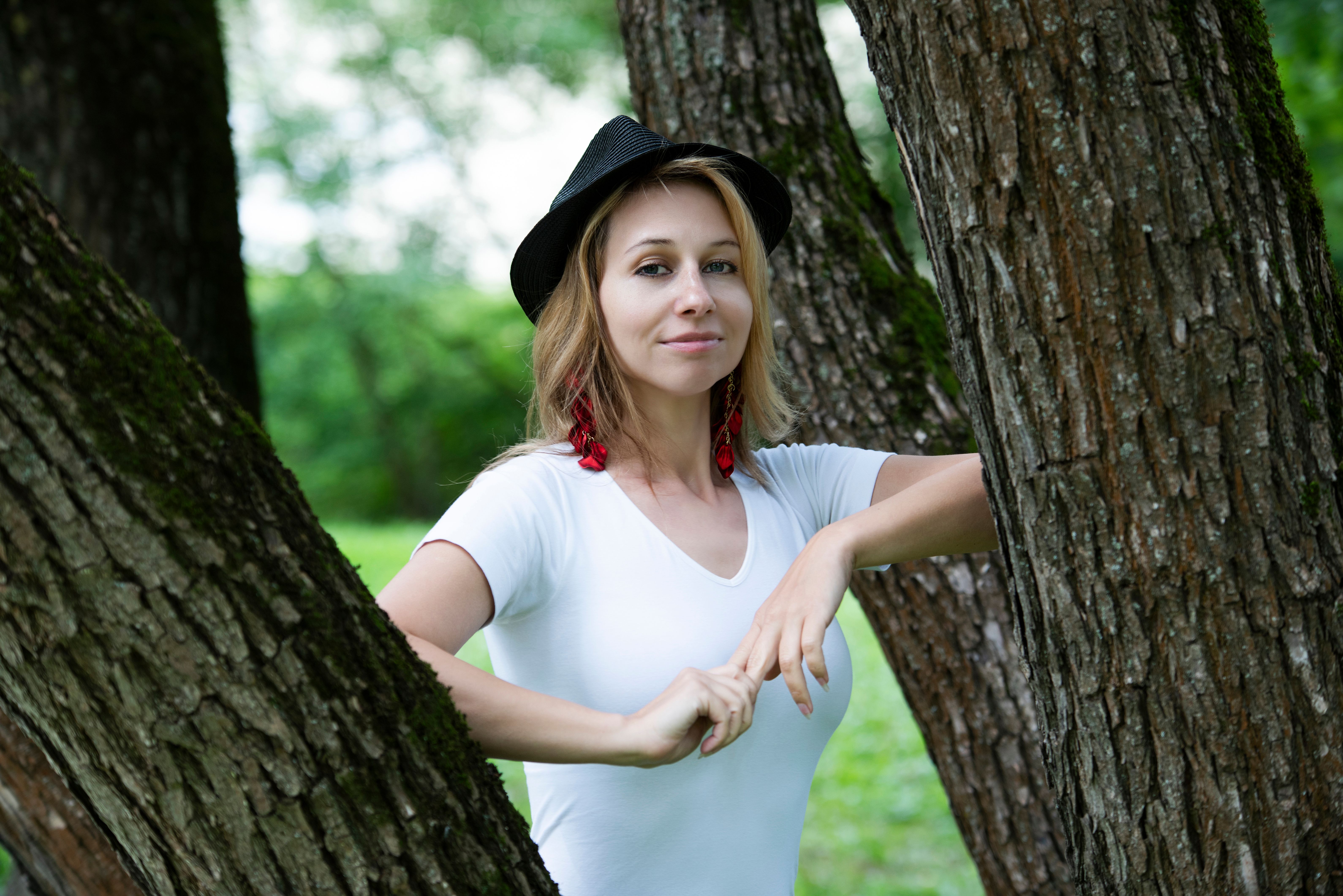 A Woman Standing by a Tree · Free Stock Photo