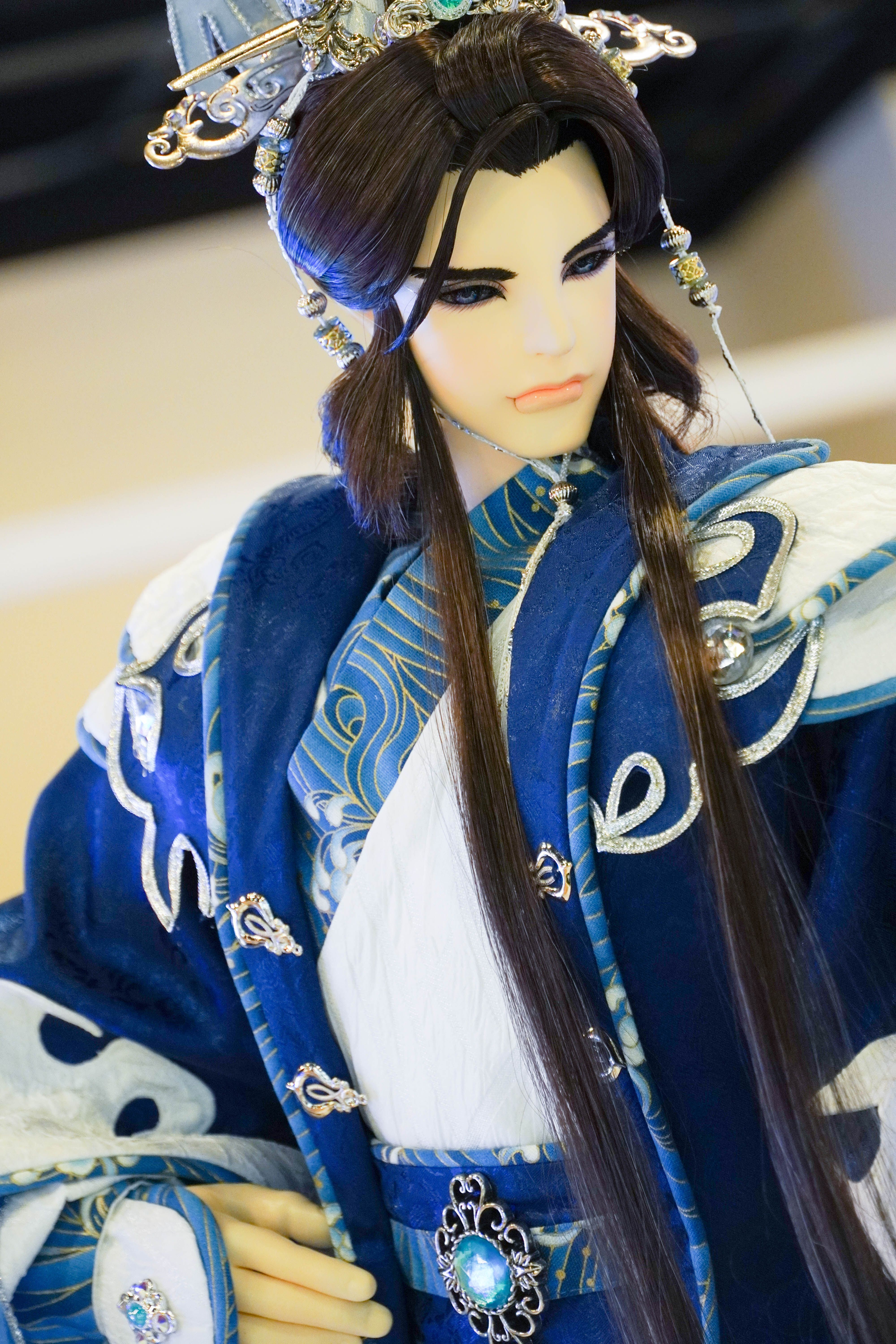 Detailed figure of an Asian mannequin wearing elaborate blue attire and silk kimono.