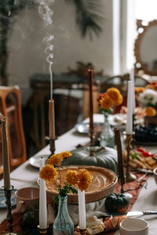 Free Warm and inviting autumn table setting featuring pumpkins, candles, and fall flowers. Stock Photo