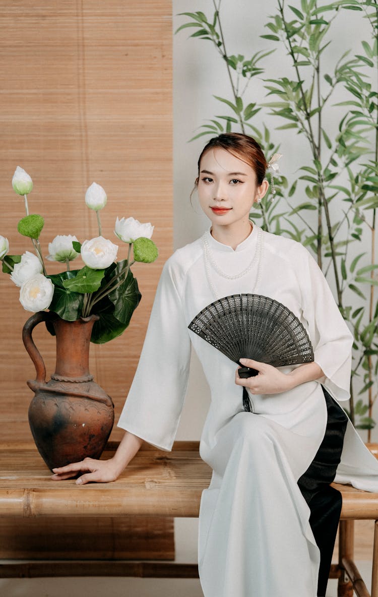 Woman In Traditional Clothing And With Fan