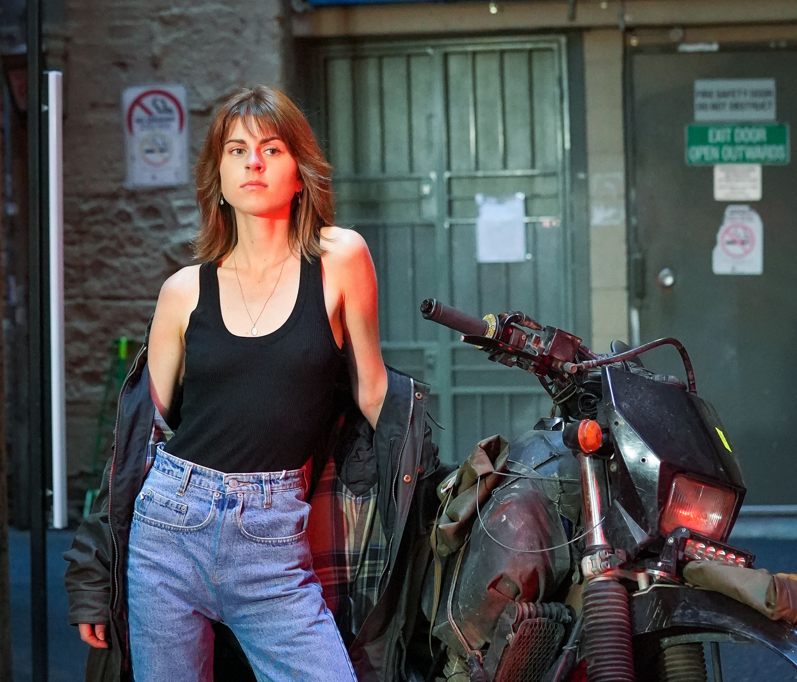 A Woman Standing by a Motorcycle · Free Stock Photo