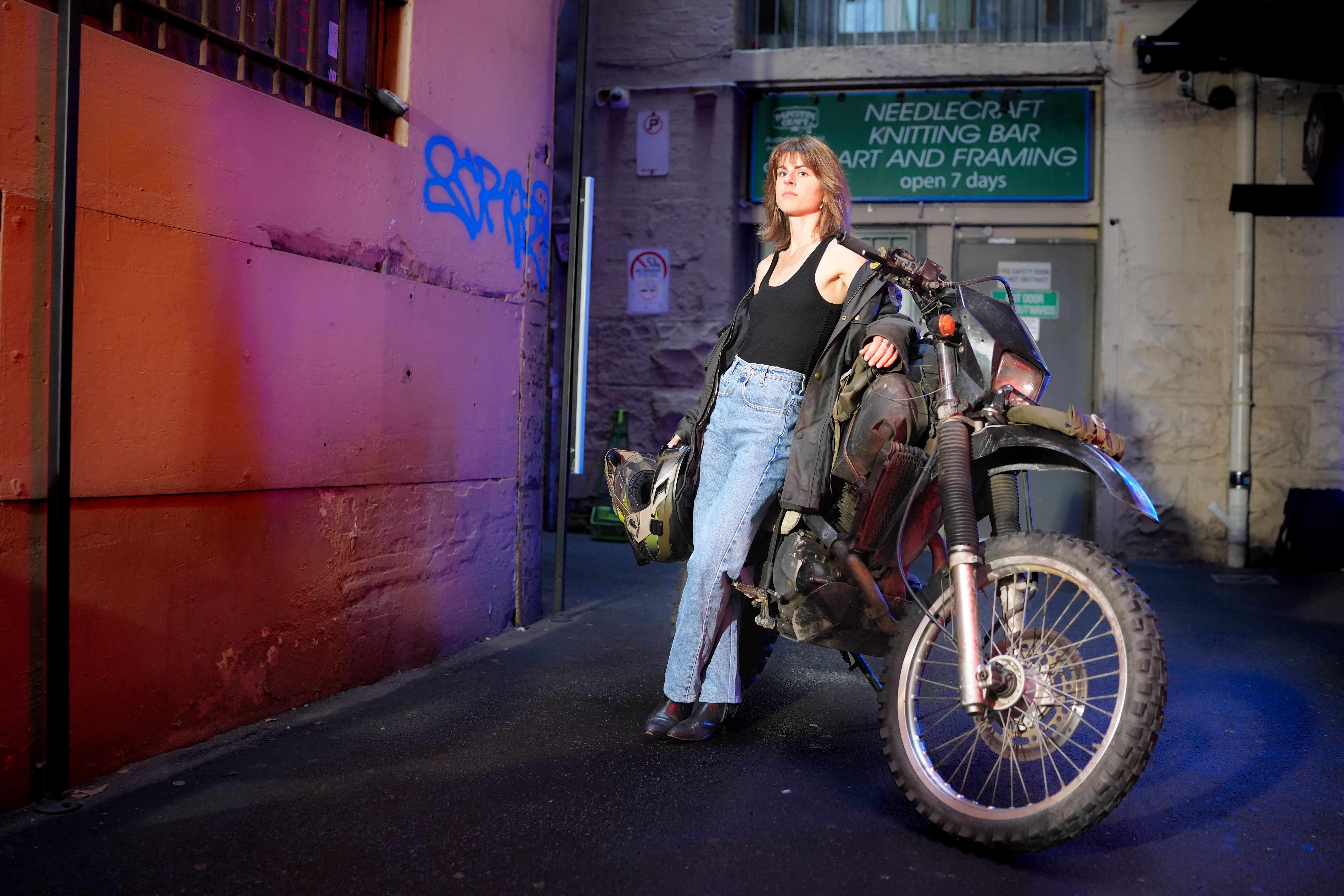 Young Woman Standing next to a Motorbike · Free Stock Photo