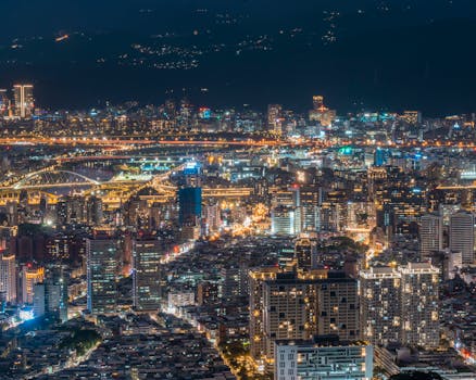 A breathtaking night view of Taipei city showcasing its modern illuminated skyline and architecture.