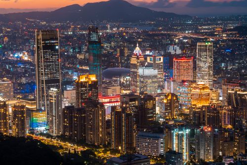 Free Explore the illuminated skyline of Taipei at twilight, showcasing modern skyscrapers and vibrant city lights. Stock Photo
