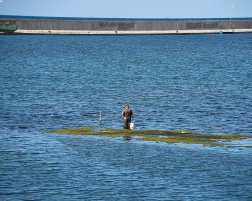 Fisherman Standing in the Sea