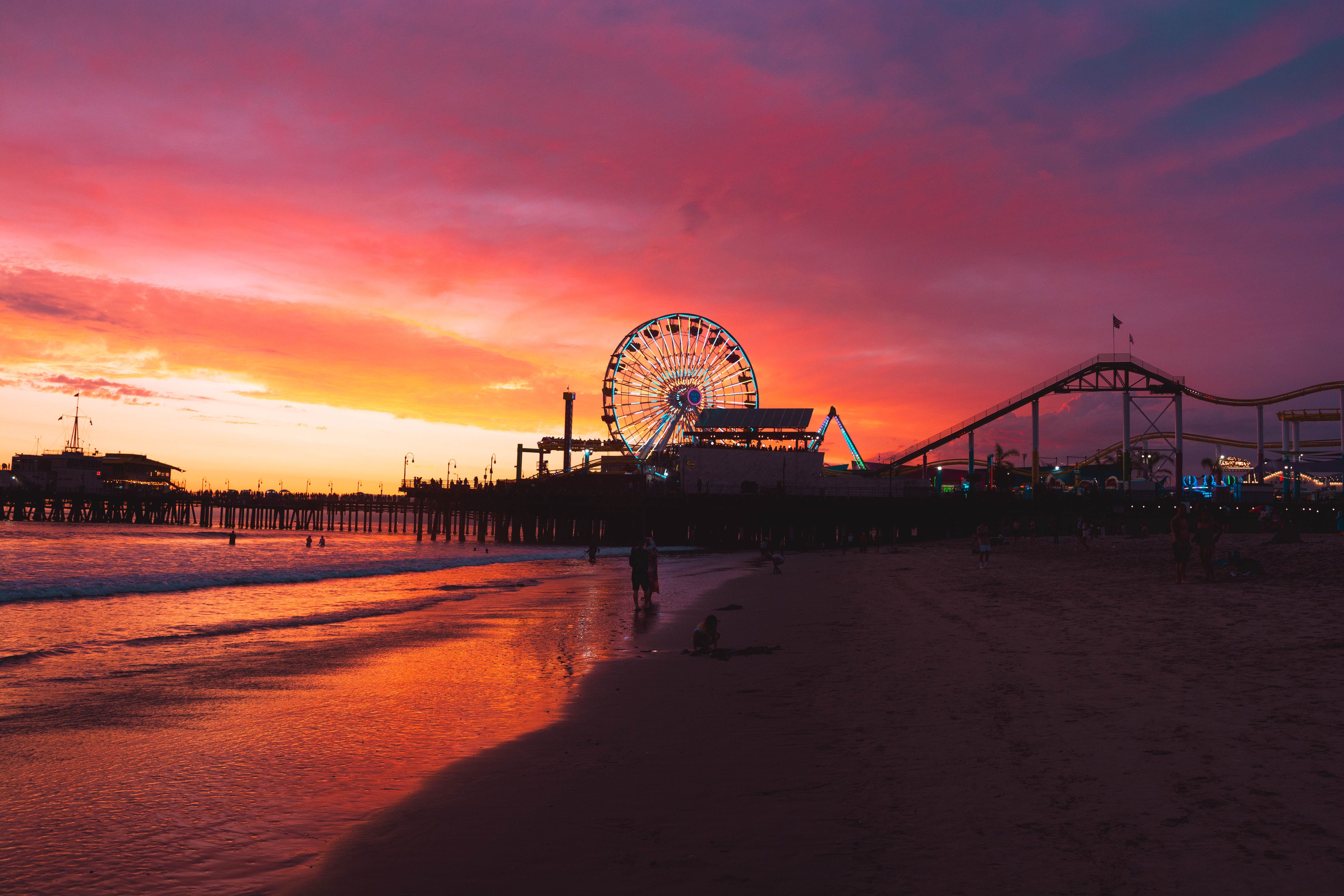 Breathtaking sunset over Santa Monica Pier with illuminated Ferris wheel and vibrant skies
