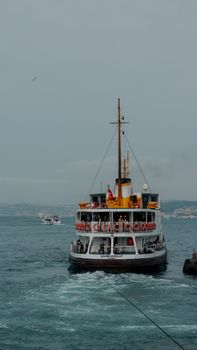 A classic ferry navigating the Bosphorus waters in Istanbul, Türkiye, capturing local maritime culture.