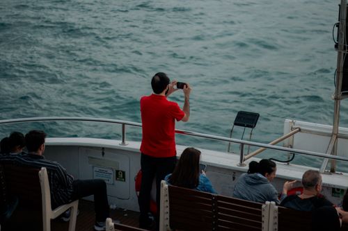 Free A man capturing sea views on a ferry in İstanbul. Perfect for travel and tourism themes. Stock Photo